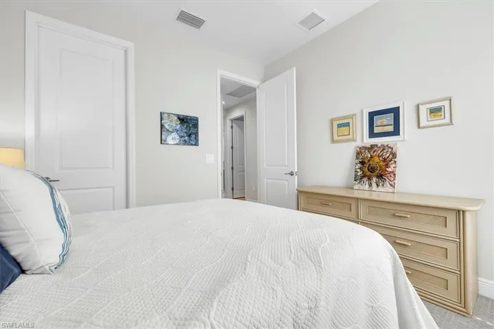 White paneled interior doors, light gray wall color, recessed lighting, and light-colored carpet flooring