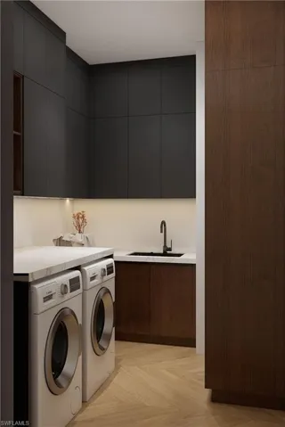 Laundry room featuring cabinet space, parquet floors, and independent washer and dryer (Rendered photo)