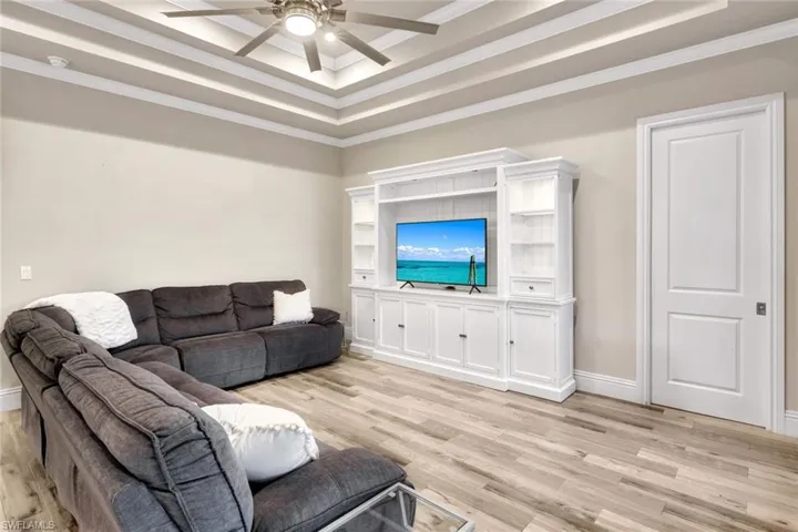Notice the triple cove ceiling detail in the great room and the wood-like tile flooring throughout the home.