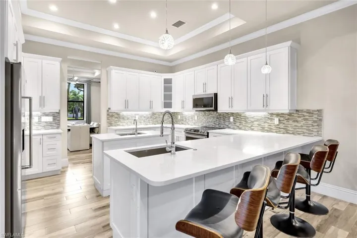 Kitchen features stainless appliances, shaker cabinets, TWO sinks and a double island...