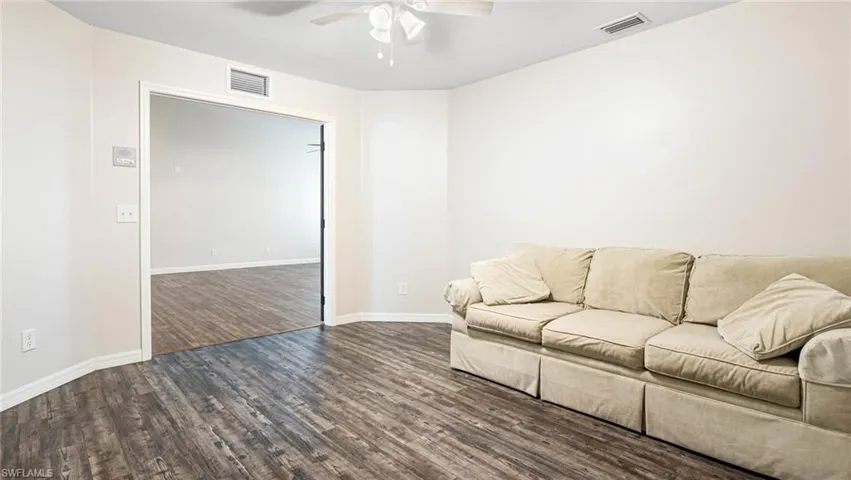 Office with dark LPV flooring and ceiling fan