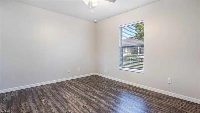 Guest room featuring LPV floors and ceiling fan