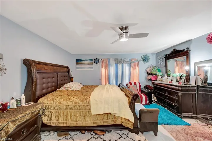 Carpeted bedroom with ceiling fan