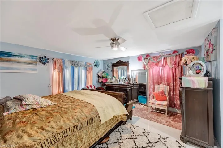 Bedroom featuring light tile patterned flooring and ceiling fan