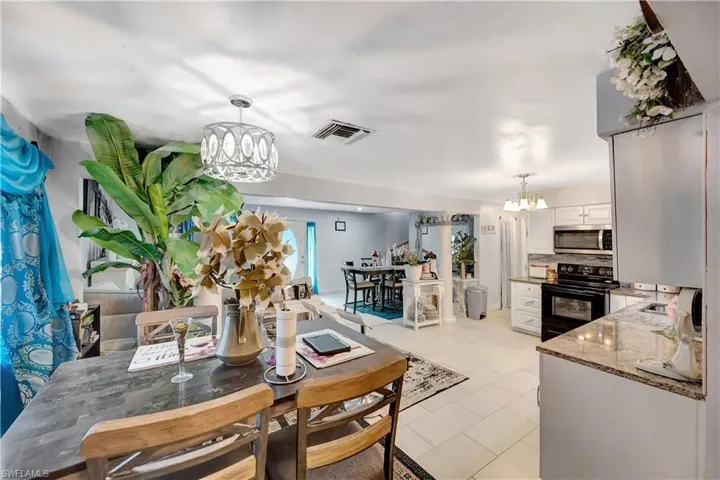 Dining area featuring a notable chandelier and light tile patterned floors