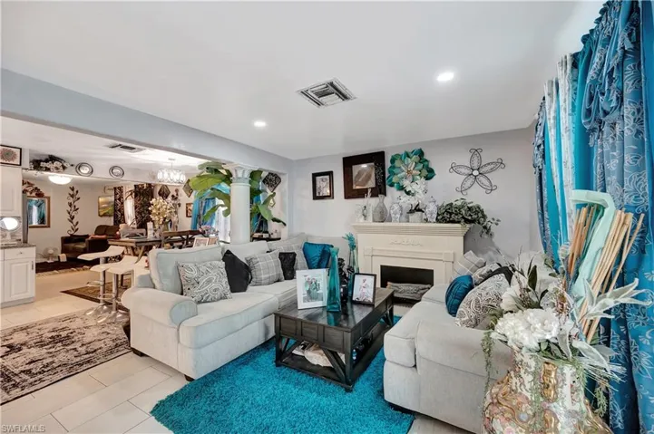 Living room with light tile patterned flooring