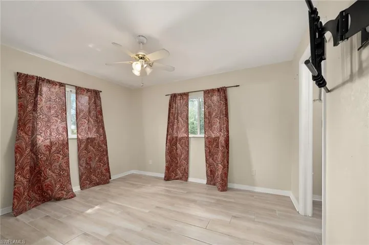 Empty room featuring ceiling fan and light wood-type flooring