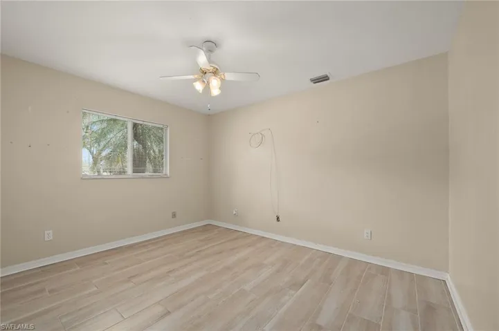 Unfurnished room featuring ceiling fan and light hardwood / wood-style floors