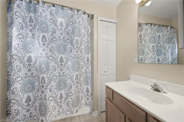 Bathroom with vanity and curtained shower