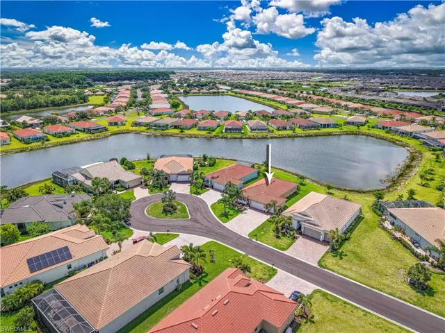 Aerial perspective of suburban area featuring a large body of water