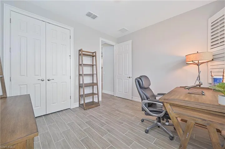 Office space with baseboards and wood finished floors