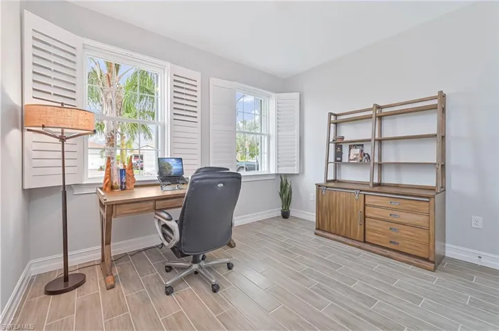 Office space with baseboards and wood finish floors