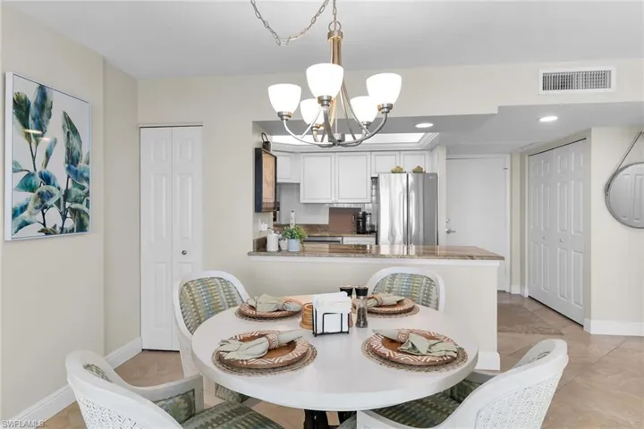 Dining room featuring a chandelier and baseboards
