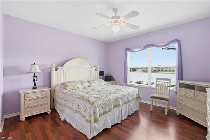 Bedroom with dark wood-style floors and a ceiling fan