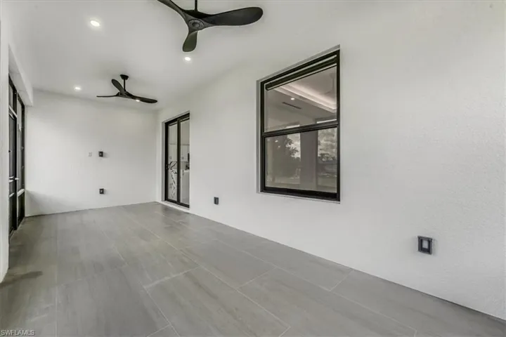 Empty room with a ceiling fan and recessed lighting