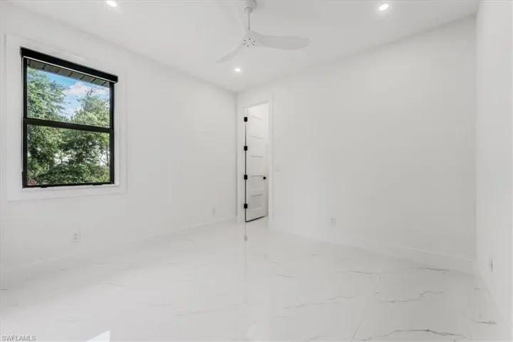 Unfurnished room featuring light marble finish flooring, recessed lighting, and ceiling fan