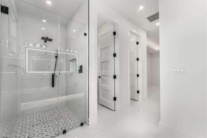 Full bathroom with a marble finish shower, recessed lighting, and marble finish floors
