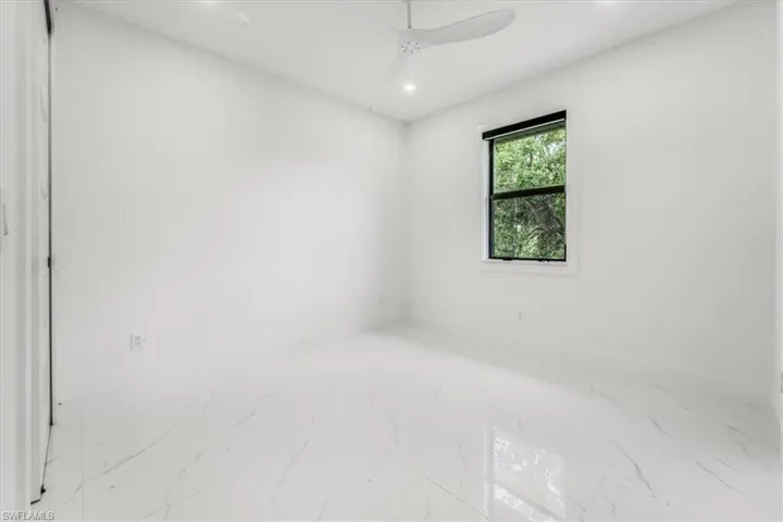 Unfurnished room with marble finish floors, recessed lighting, and ceiling fan