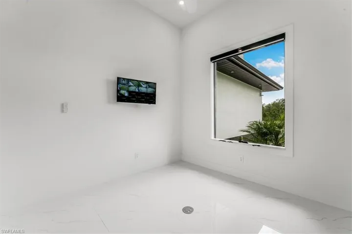 Den with marble look tile flooring