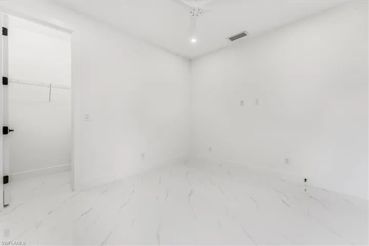 Empty room featuring marble finish flooring and recessed lighting
