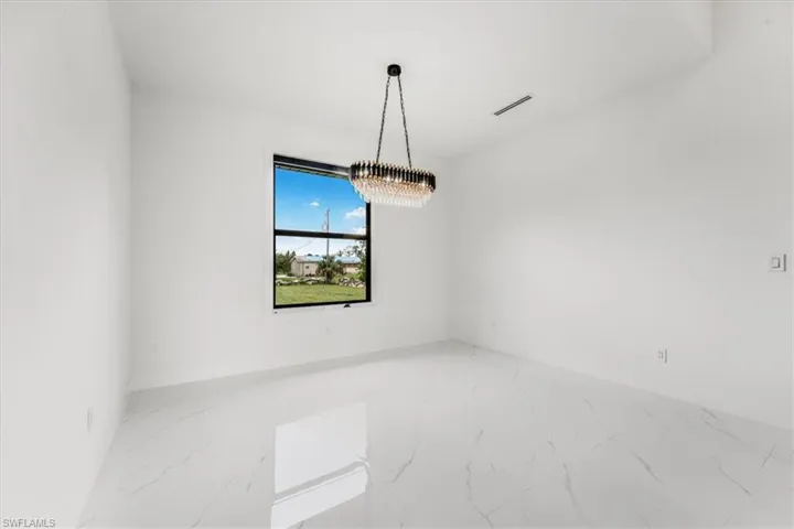 Unfurnished room featuring marble finish flooring