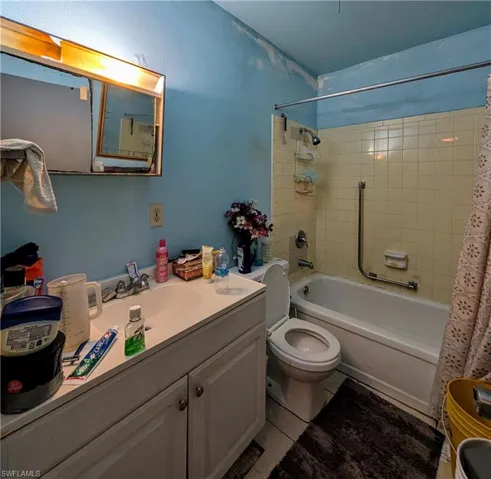 Full bathroom with shower / bath combo, vanity, and toilet