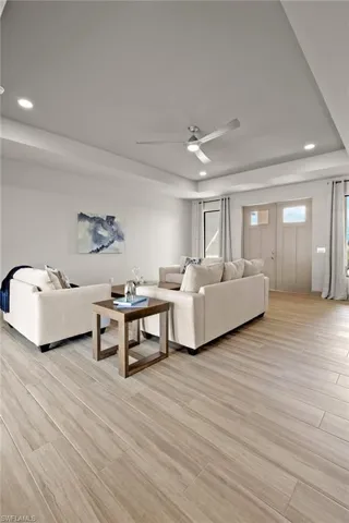Living room featuring light hardwood / wood-style flooring and ceiling fan