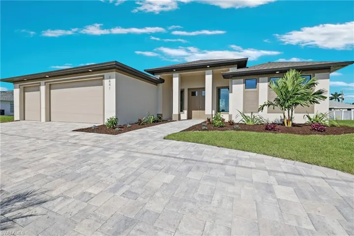 Prairie-style house with a front yard and a garage