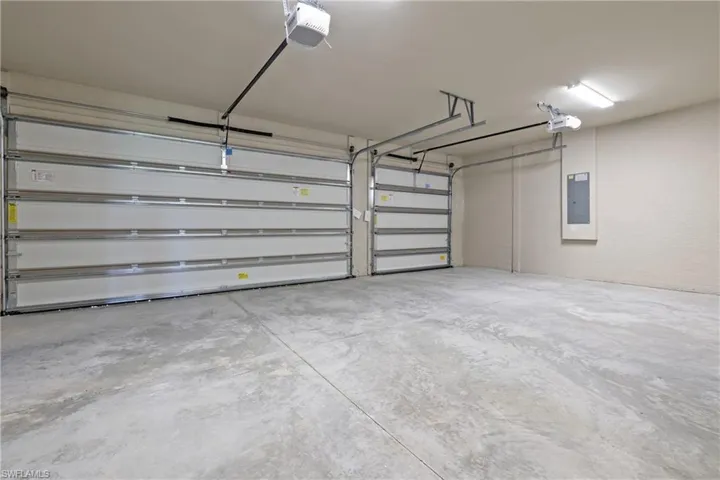 Garage with electric panel and a garage door opener