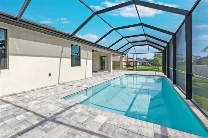 View of swimming pool with a lanai and a patio area