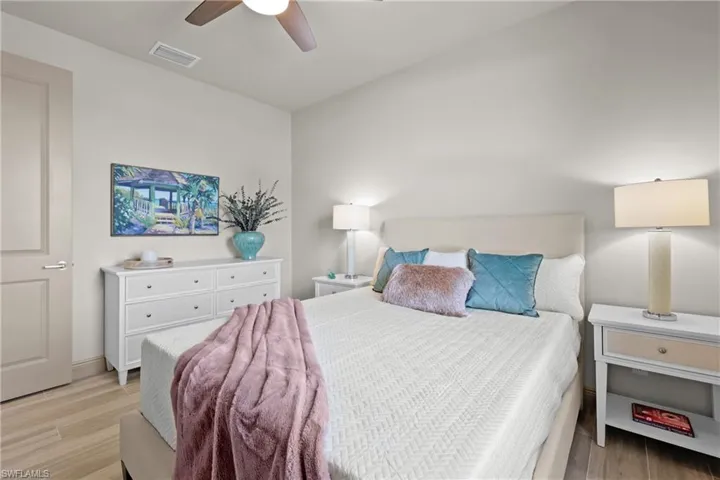 Bedroom featuring ceiling fan and light hardwood / wood-style flooring