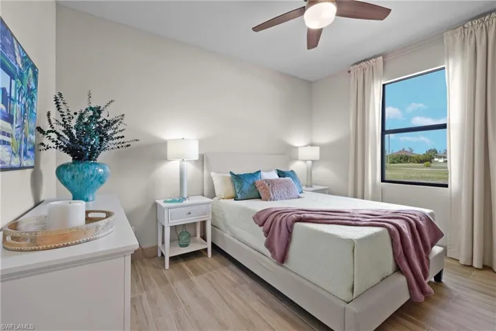 Bedroom featuring ceiling fan and light hardwood / wood-style flooring