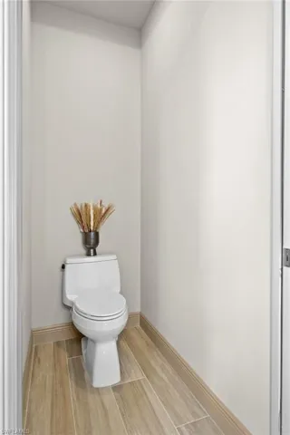 Bathroom featuring hardwood / wood-style floors and toilet