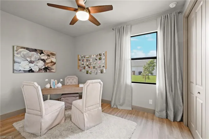 Dining area featuring light wood-type flooring and ceiling fan