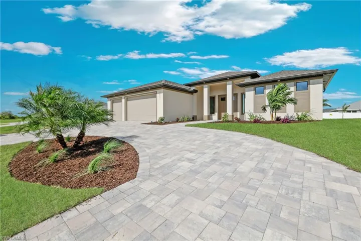Prairie-style home with a garage and a front yard