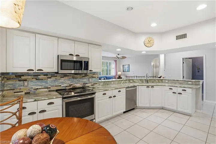 The kitchen is bright and open, with plenty of natural light and cabinet space.