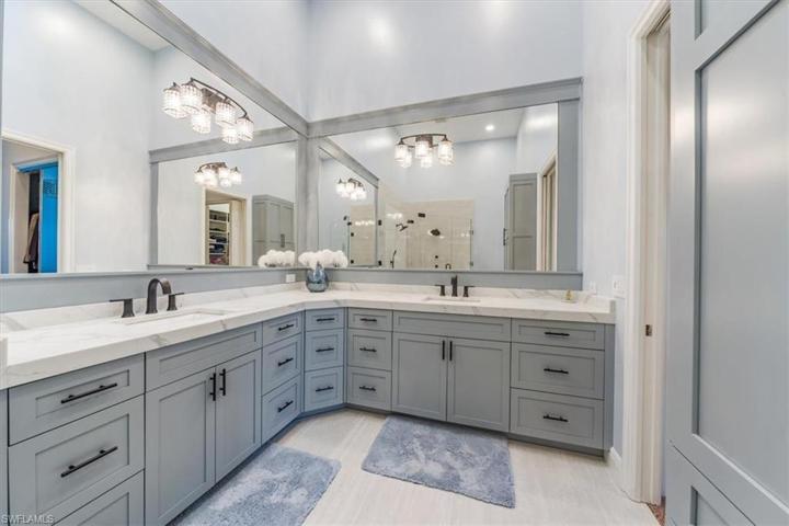 Remodeled Ensuite with gentleman height vanities custom counters, mirrors and lighting