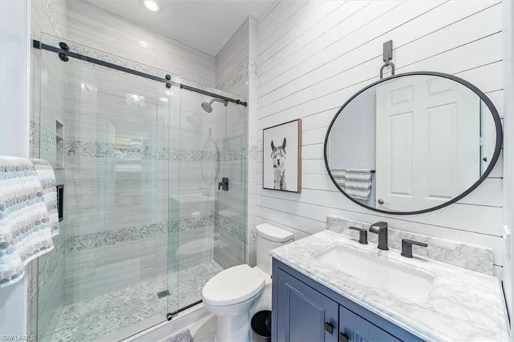 Main Bathroom with premium tile and shiplap accent wall.