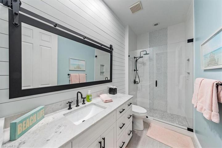Bathroom number 2 with premium tile and shiplap accent well.