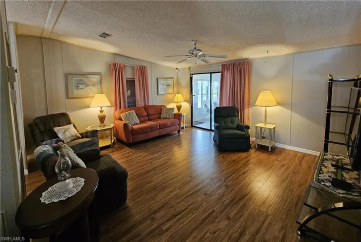 Living area with wood finished floors and a ceiling fan