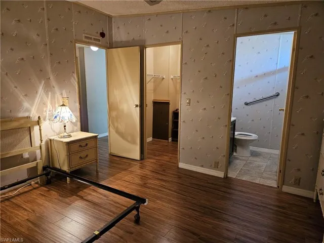 Primary bedroom with ensuite bathroom and walk-in closet