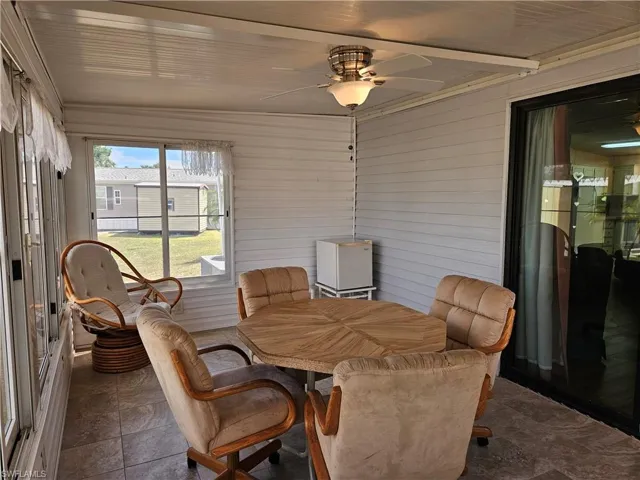 Sunroom featuring ceiling fan and outdoor dining area
