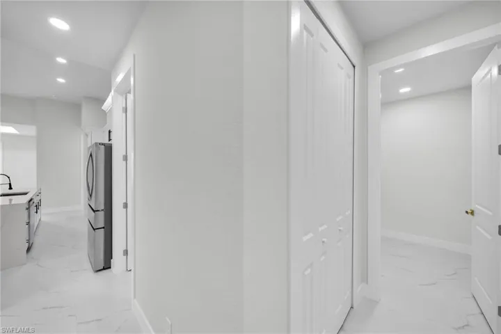 Hall with sink and light tile patterned flooring