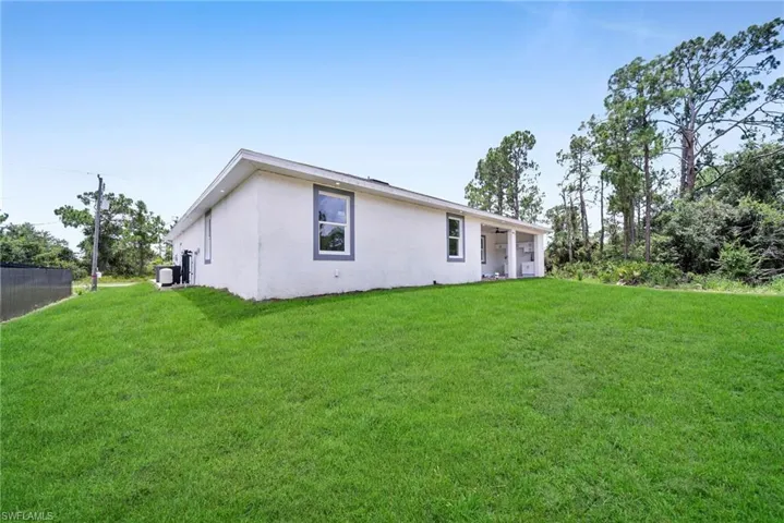 Back of house with a lawn