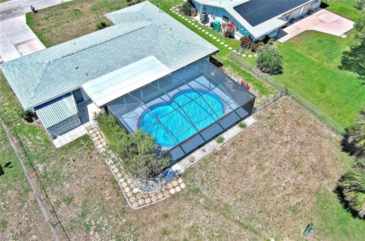 Aerial view featuring the proprty, and pool