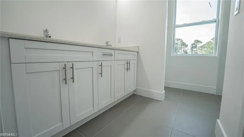 Full bathroom with tile patterned flooring and double vanity