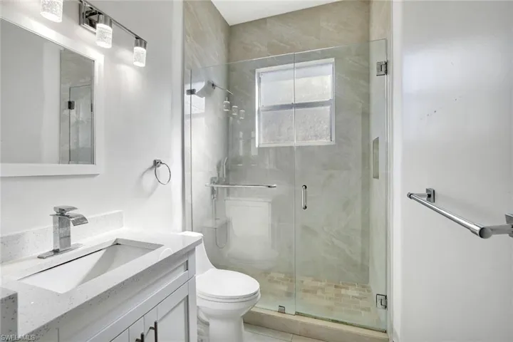 Full bathroom featuring vanity and a stall shower
