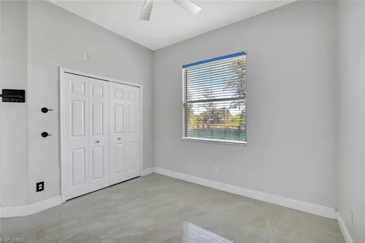 Unfurnished bedroom with a closet and a ceiling fan
