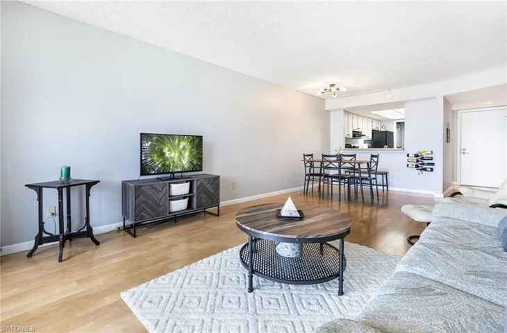 Living room featuring light hardwood / wood-style flooring and a textured ceiling