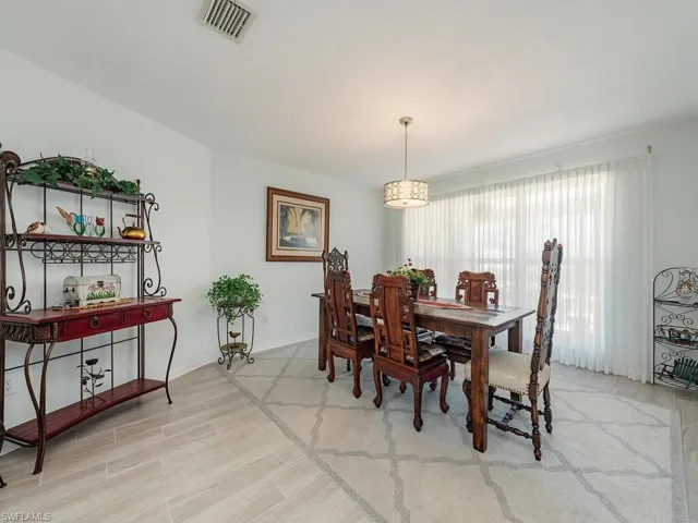 Dining room featuring baseboards, visible vents, and light wood-type flooring